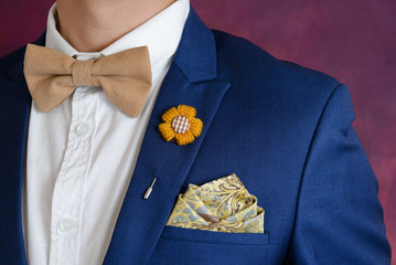 man in blue suit bowtie, pocket square