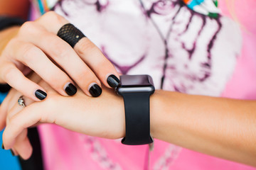 Heart rate monitor smart watch for sport. Athlete wearing heart rate monitor. Runner using sports smartwatch on running workout outside. Female athlete tracking activities using wearable technology.