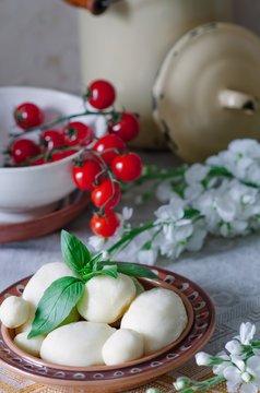 Home mozzarella with fresh basil, cherry tomatoes on the table