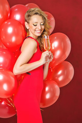 Beautiful lady with balloons and champagne