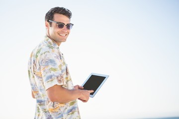 Smiling man using tablet