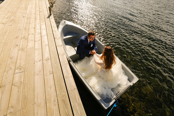 groom and bride sitting in a boat