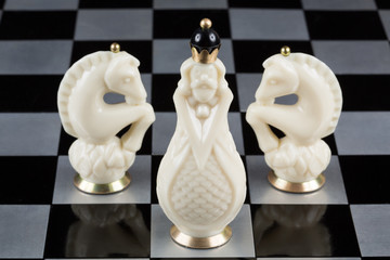 Glass chess pieces on a chessboard
