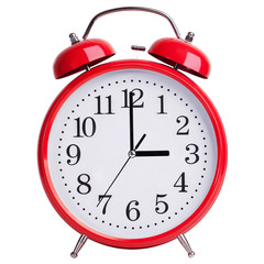 Red alarm clock shows exactly three hours