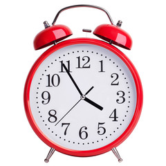 Red alarm clock shows five minutes to four