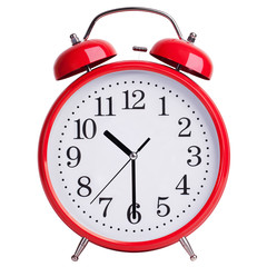 Red alarm clock shows half past ten