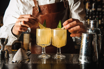 Barman is decorating cocktail  no face