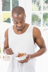 Young man having breakfast cereals