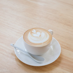 Hot art Latte Coffee in a cup on wooden table