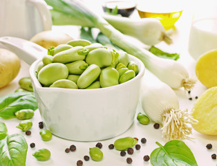 Ceramic dipper of fava beans with ingredients for cream soup
