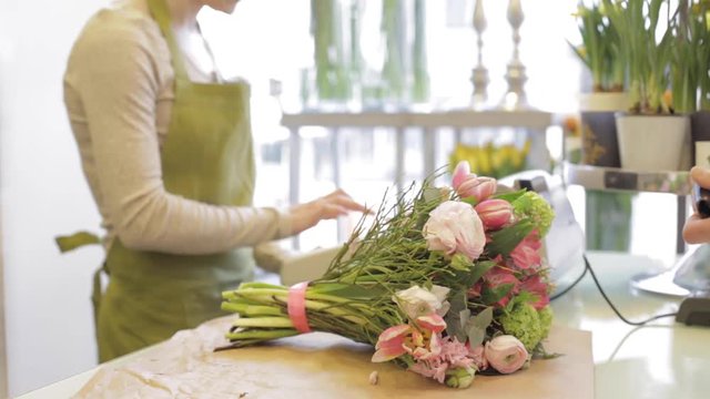 florist woman with flowers and man at flower shop