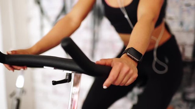 Smart watch showing a heart rate of exercising woman in gym