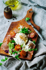 Summer salad with mozzarella, cherry tomatoes, lettuce and prosciutto