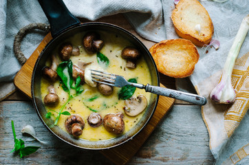 Melting mozzarella in pan with mushrooms, basil and garlic croutons