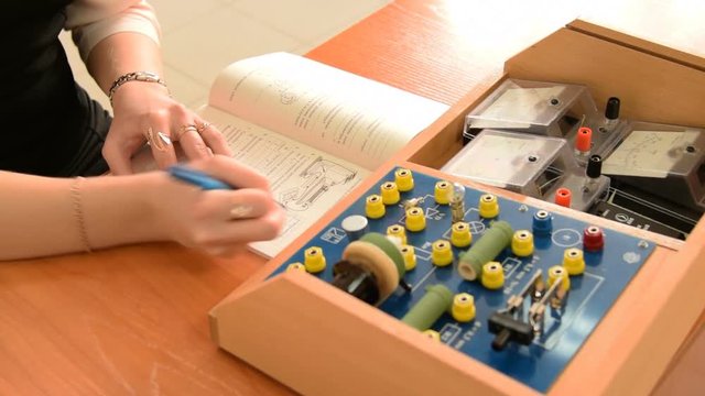 Girl and physics equipment at school