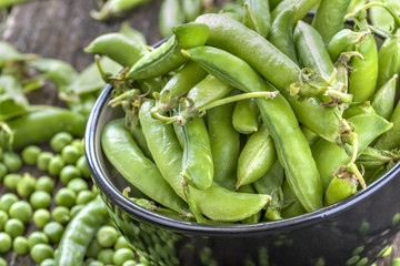 freshly picked organic peas on a rustic wooden table