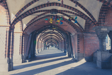 many colorful shoes hanging on bridge in Berlin, kreuzberg