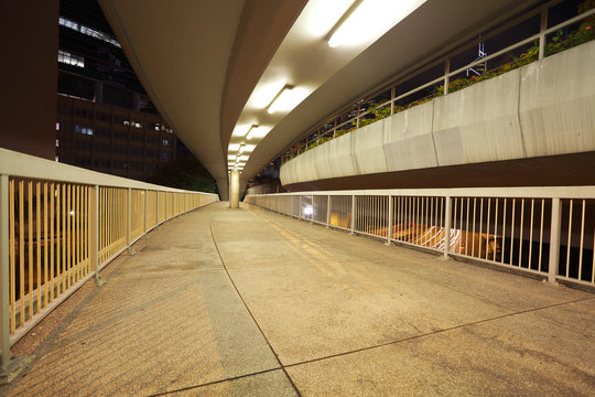 Pedestrian bridge perspective  long corridor of night