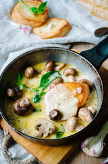 Melting mozzarella in pan with mushrooms, basil and garlic croutons