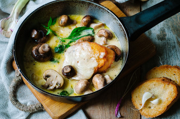 Melting mozzarella in pan with mushrooms, basil and garlic croutons