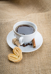 Cup of coffee, cookie on sackcloth background