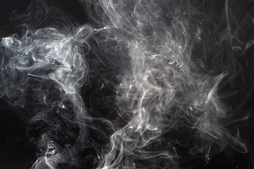 Smooth grey smoke isolated on dark black background