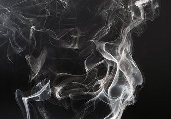 Smooth grey smoke isolated on dark black background