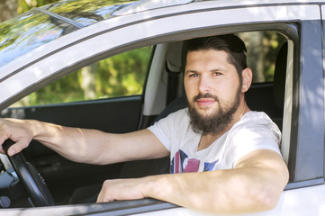 Handsome man driving a car. Stylish man. Bearded and handsome ma