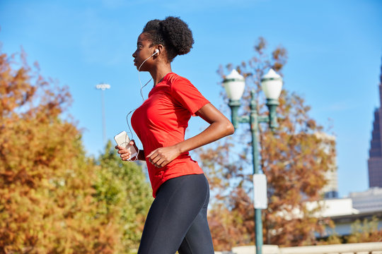 Runner girl running listening music earphones