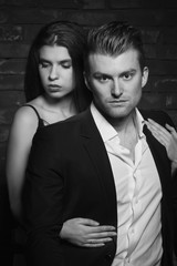 Portrait of young fashionable man and beauty brunette girl