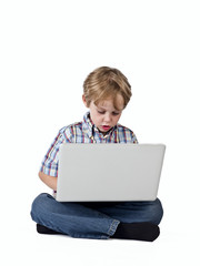 boy browsing on laptop.