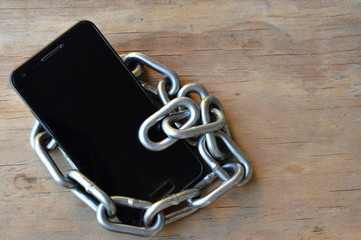 chain roll over cell phone on wooden board