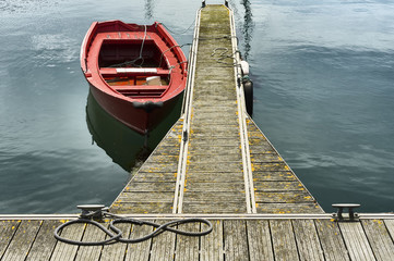 red wooden boat and rope on marina port