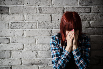 Fototapeta na wymiar Depressed young crying woman - victim