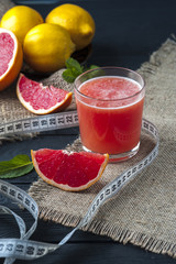 Measuring tape and fresh grapefruit juice