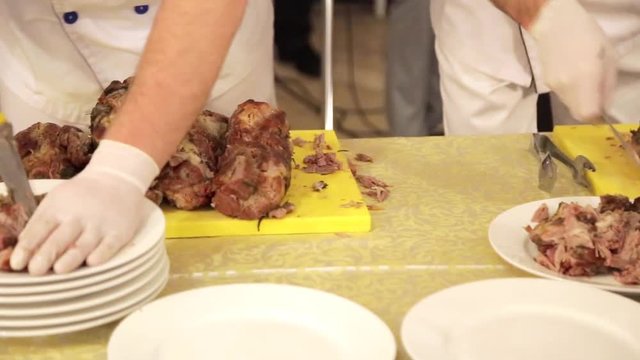 Chef carving roast pork