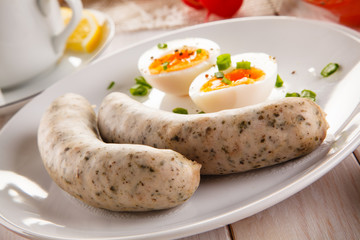 Easter breakfast - eggs, boiled white sausages and vegetables