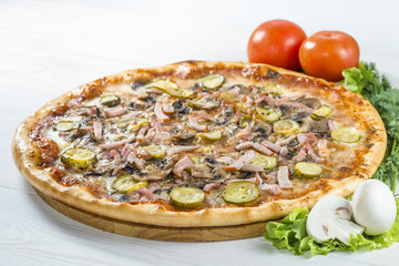 delicious pizza on wooden board with tomato and mushrooms