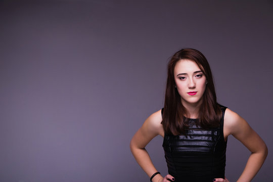 young confident young woman over dark background