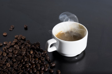 small white cup of steaming espresso. Very hot