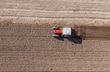 Fototapeta na wymiar aerial view of the tractor on the harvest field