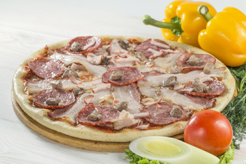 tasty pizza on a wooden board with beautiful vegetables