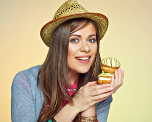 Smiling woman holding two cake.