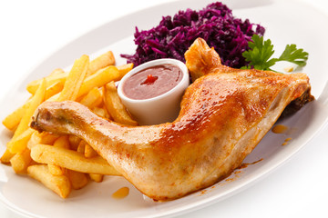 Roast chicken legs with chips and vegetables