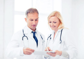 two doctors looking at tablet pc