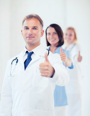 doctor with stethoscope and colleagues