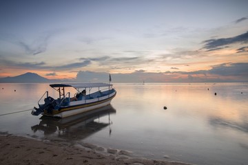 Sanur beach in the morning at Bali, Indonesia with traditional balinese fishing boat