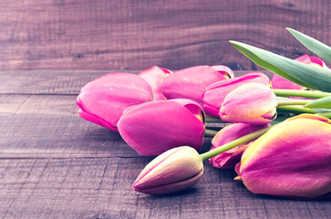 Pink tulips on rustic wooden background. Spring flowers. 