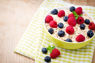 Oatmeal porridge with berries. Raspberries and blueberries.