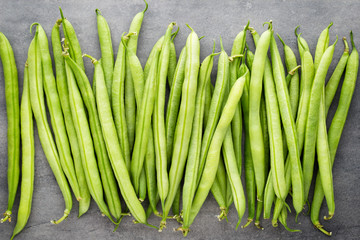 Green beans  on a gray background.